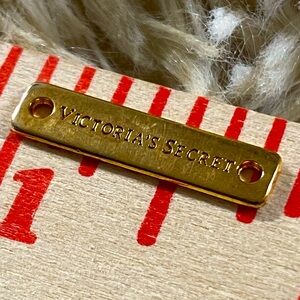 Victoria’s Secret metal lable bar bead gold